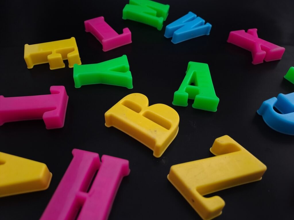 Close-up of colorful alphabets on black background perfect for children's education.