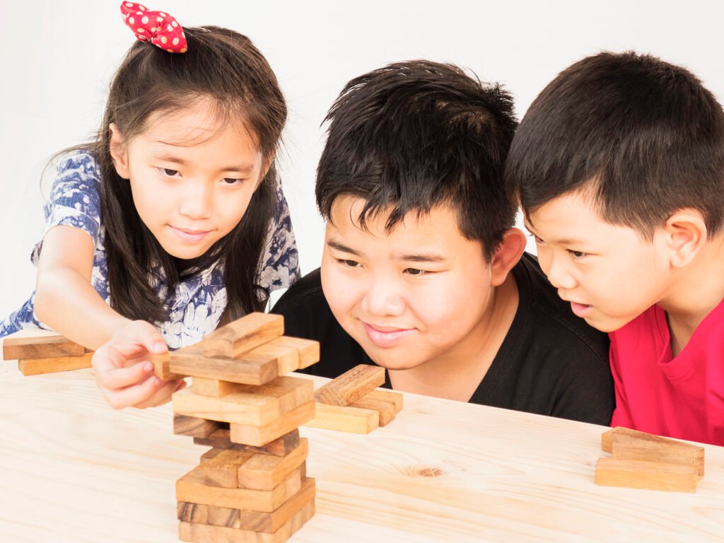 children-is-playing-a-wood-blocks-tower-game-for-practicing_